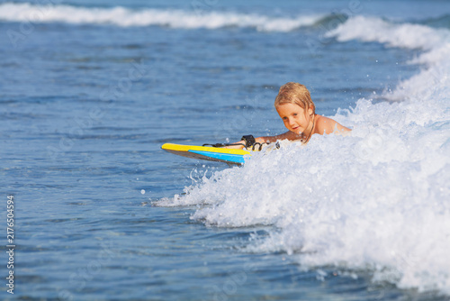 Photography Happy young surfer boy with bodyboard have fun on beach, riding on small ocean waves