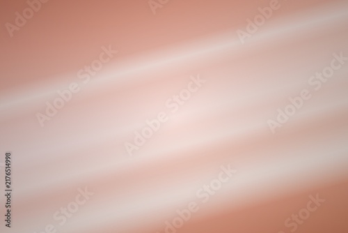 Soft focus abstract background featuring smooth flowing light and pastel orange gradient texture