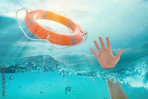 Foto Man drowning in ocean trying to catch lifebuoy, closeup