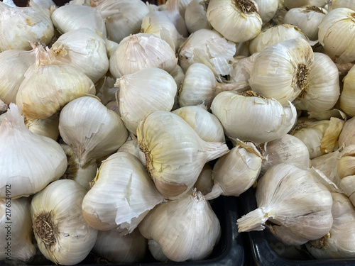 A bin full of fresh garlic at a farmer's market
