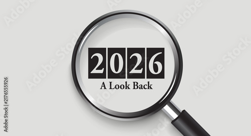 Obraz na płótnie Magnifying glass focusing on 2026 year text on white numbers inside black blocks with A Look Back headline on a smooth grey background