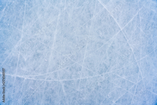 Fotografía Ice background with marks from skating and hockey, blue texture of rink surface