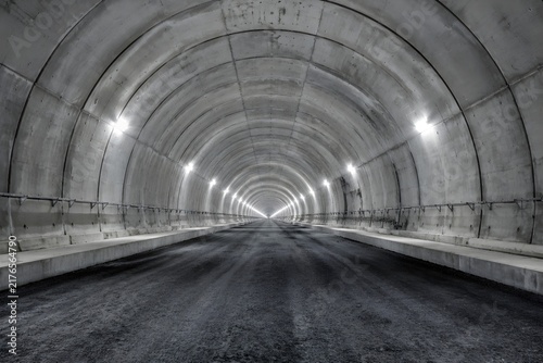 Underground Highway Tunnel Construction With Fresh Concrete Lining Unfinished Asphalt Base and Repeating Structural Ribs