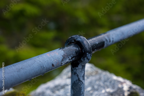 Obraz na płótnie Close-up of corroded metal pipe joint with black oxidation, Norway