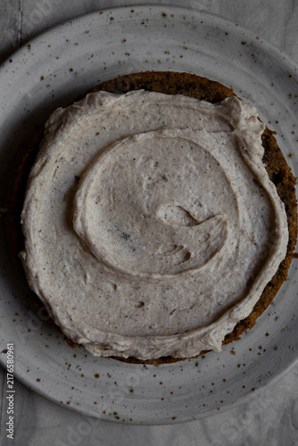 Close up buttercream swirl on cake served in ceramic plate.
