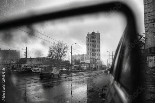 Urban Reflection - A Monochrome View of Cityscape Through Car Mirror.