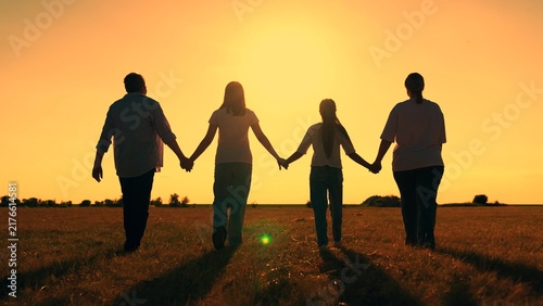 Dad mom, children walk, outdoors. Family picnic with children. Happy family, sun meadow. Parents father mother child daughter playing together on grass, holding hands. Freedom. Slow motion. Silhouette