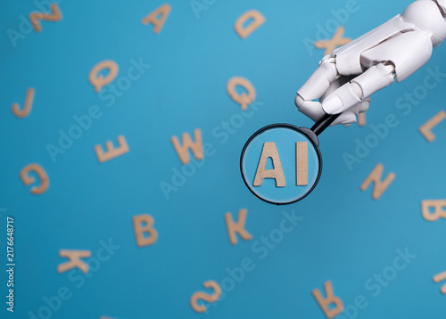 Robotic Hand Holding Magnifying Glass over AI Letters Concept