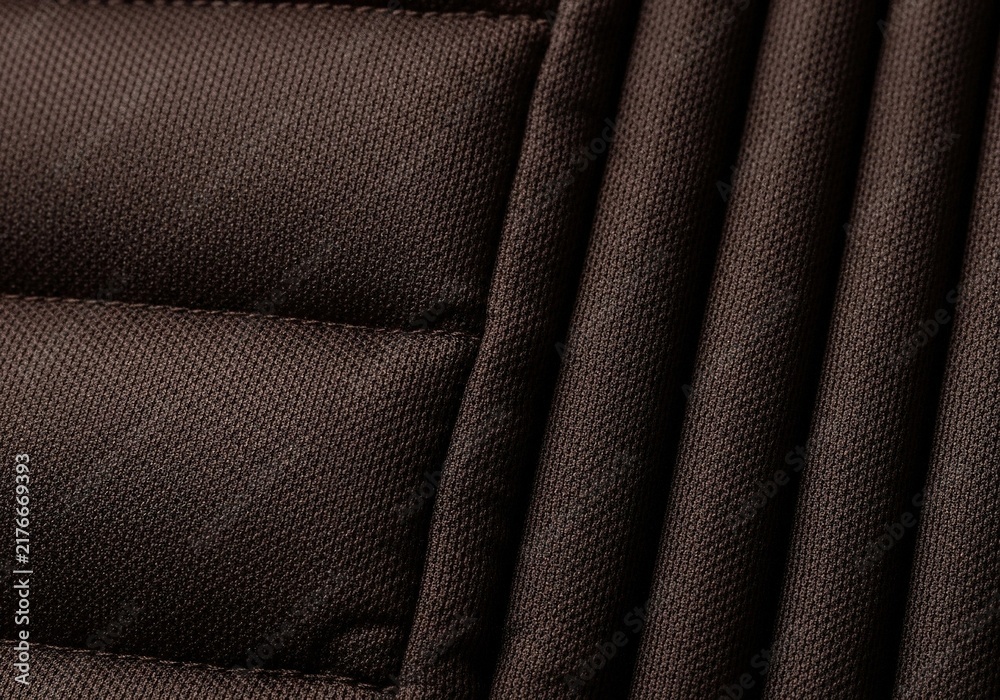 Obraz premium Close up view of dark brown quilted fabric texture with horizontal and vertical stitching lines.