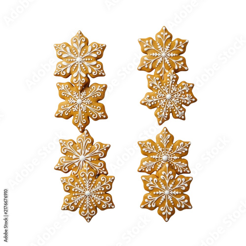 Eight photorealistic, golden-brown gingerbread snowflake cookies with intricate white royal icing filigree, arranged symmetrically on a transparent flat lay surface. Festive holiday baking concept