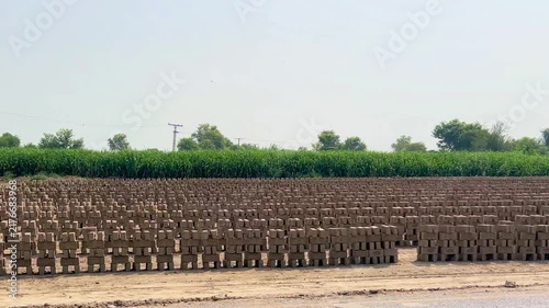 The clay bricks are standing in a single row, with each brick placed on top of another. 4k video