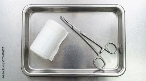 Cuadro en lienzo Sterile gauze roll resting beside forceps on a surgical prep tray