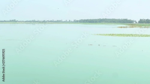 A breathtaking high-angle view of a vast tranquil lake stretching across the landscape. 4k video