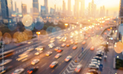 A vibrant cityscape during twilight with blurred car lights creating bokeh effects, showcasing the urban hustle and bustle at dusk.