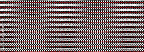 black-and-white geometric harlequin pattern features repeating vertical diamonds containing tiny playing card suit symbols, including spades, hearts, diamonds, and clubs.