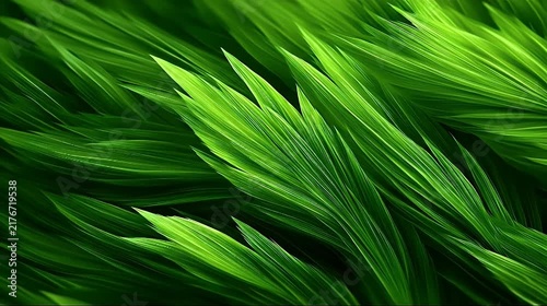 Extreme macro close-up of vibrant green grass blades with detailed textures and veins.