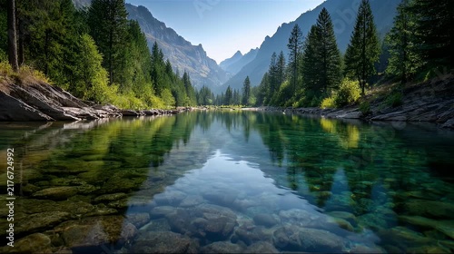 Pristine mountain lake with crystal clear water and pine forest reflection.