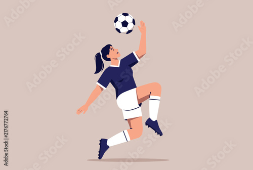 Athletic young female soccer player in blue sportswear juggling football with her knee in dynamic jump pose outdoors.
