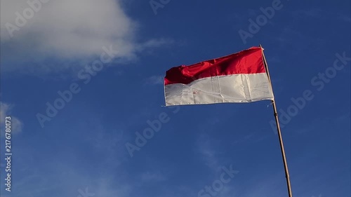 waving flag of Indonesia against blue sky, part 3