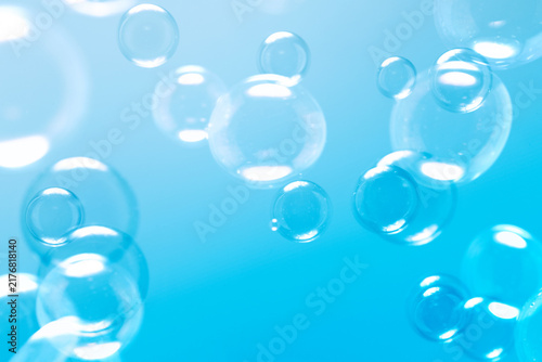 Clear Soap Bubbles on Blue Background. Freshness Soap Suds Bubbles Water. Celebration Festive Backdrop. Blue Gradient Blurred Background. 
