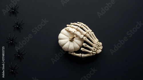 White Pumpkins and Skeleton Hand on Black