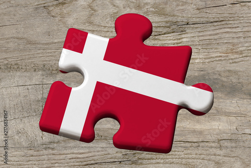 3D illustration. Flag of Denmark on a jigsaw puzzle pieces on a wood background.