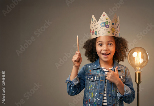 Young Girl Inventor Holding Glowing Light Bulb