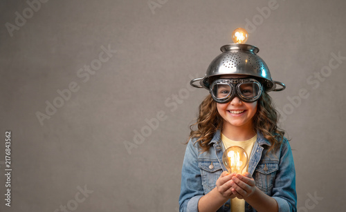 Young Girl Scientist Holding Glowing Light Bulb