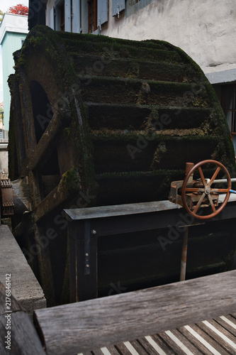 Old Wooden Water Wheel of Historic Watermill on Riverbank in Basel Switzerland