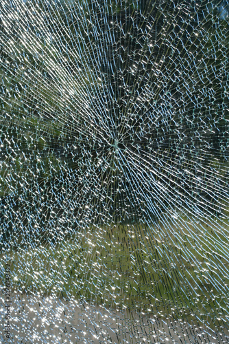 Broken glass at a public bus stop shelter after vandalism, urban infrastructure damage