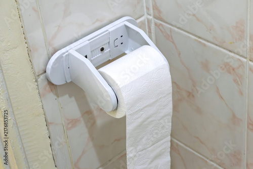 Toilet paper in a home or public restroom. White toilet paper. Hygiene or cleaning product concept. No people, nobody. Horizontal photo.