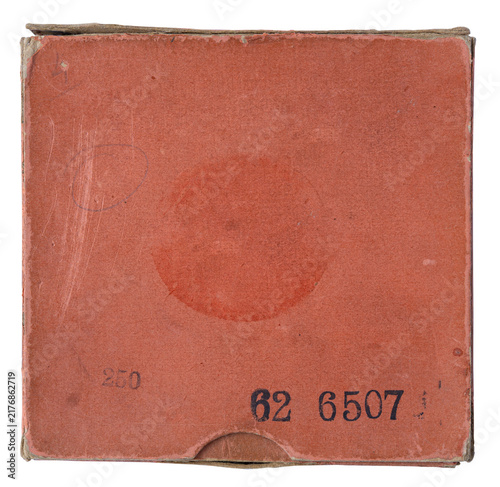 Closed red vintage magnetic audio tape reel box with a blank lined track list on a worn stained cardboard cover isolated on white