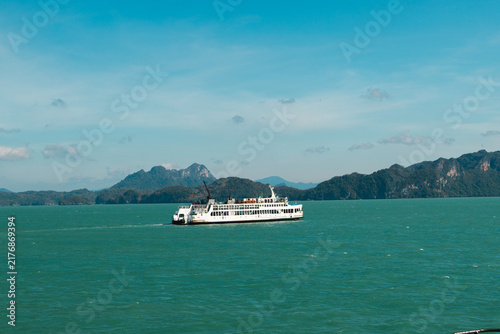 Konstfotografi Passenger Ferry Crossing Turquoise Sea Beneath Mountainous Coastline