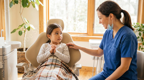 Dentist Reassuring Young Child Patient in Cozy Dental Chair Setting