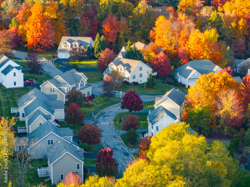 Aerial view of suburban housing community in autumn season with colorful trees