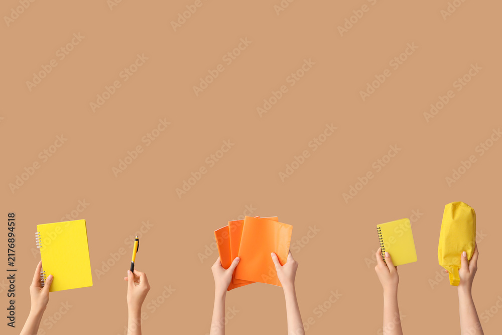 Obraz premium Female hands with set of school equipment on beige background