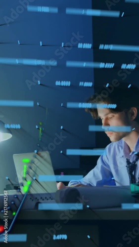 Businessman working late at desk with data processing animation overlay