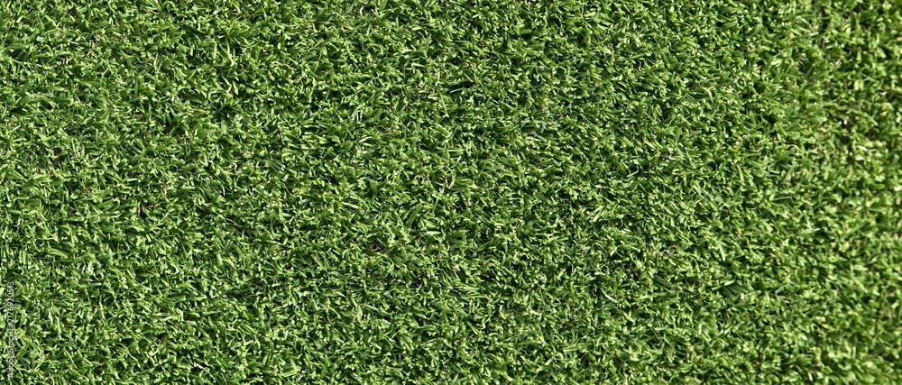 Obraz premium Close-up view of vibrant green artificial turf texture