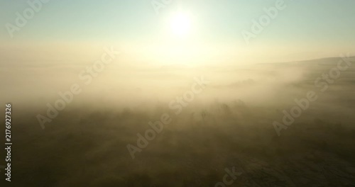 Sunrise over foggy valley