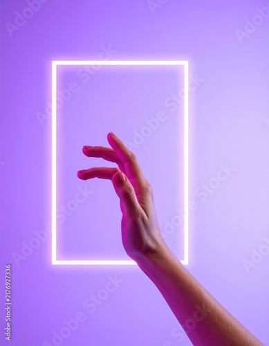 Human hand interacting with glowing geometric abstract shape