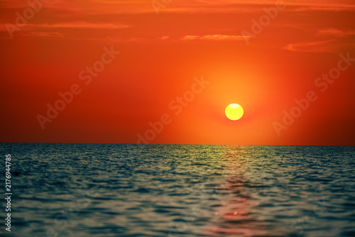 Orange Sunset Over Ocean Horizon With Calm Sea