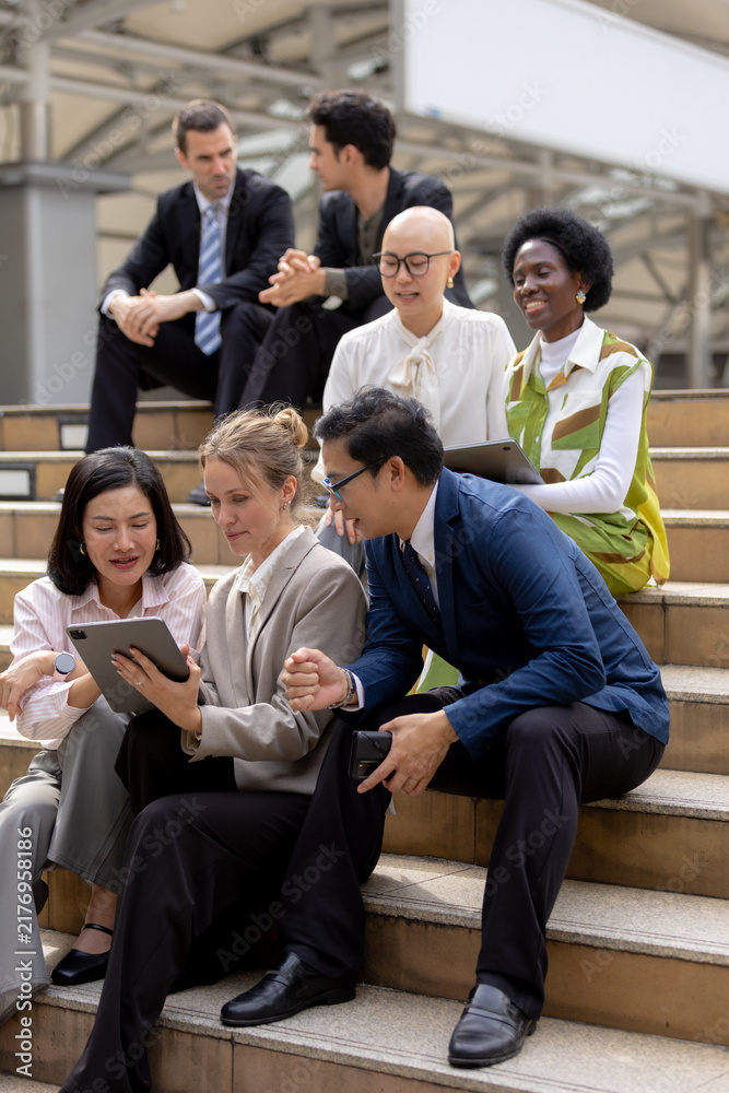 Fototapeta premium Business teamwork concept, Businessperson brainstorm colleagues discussing ideas and using tablets together while sitting outdoors in corporate setting. teamwork, business, collaboration, tablet.
