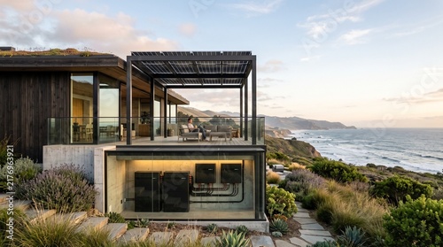 Sustainable modern luxury house by the ocean with rooftop solar panels and visible basement energy storage system inverter hardware powering coastal eco residence