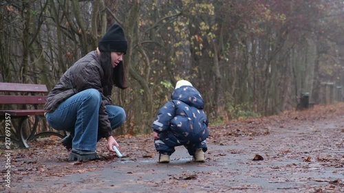 Mother and toddler in autumn park