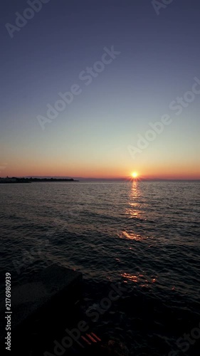 Vertical Slow Pan of Sunset Over the Sea at Dusk