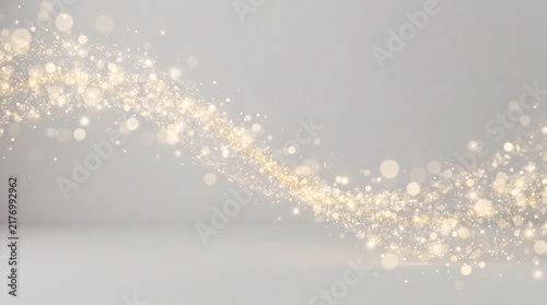 Abstract golden light wave with glitter particles and bokeh effect on a soft grey background