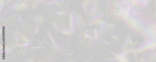 A scatter of rainbow-hued prism light fragments floats against a deep black backdrop. These multicolored shards exhibit a soft, blurred dispersion effect.
