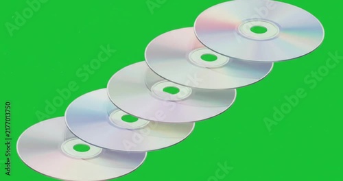 3D shiny compact discs row CDs DVDs on green screen background