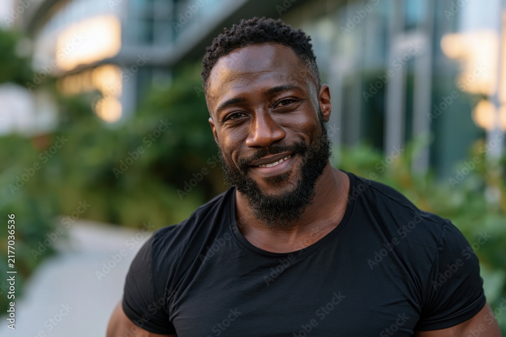 Fototapeta premium Smiling Man in Black T-Shirt Outdoors