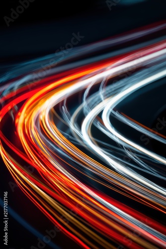 Dynamic and vibrant vertical composition featuring a variety of colorful light trails from white to red